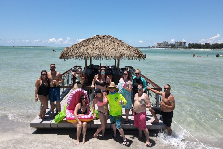 a group of people sitting at a beach