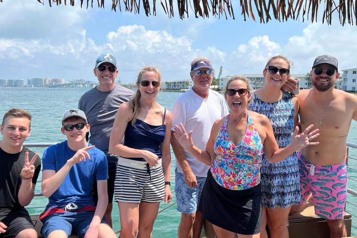 a group of people standing in front of a crowd posing for the camera