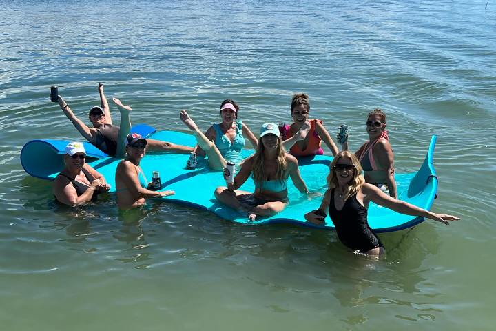 a group of people riding skis on a body of water