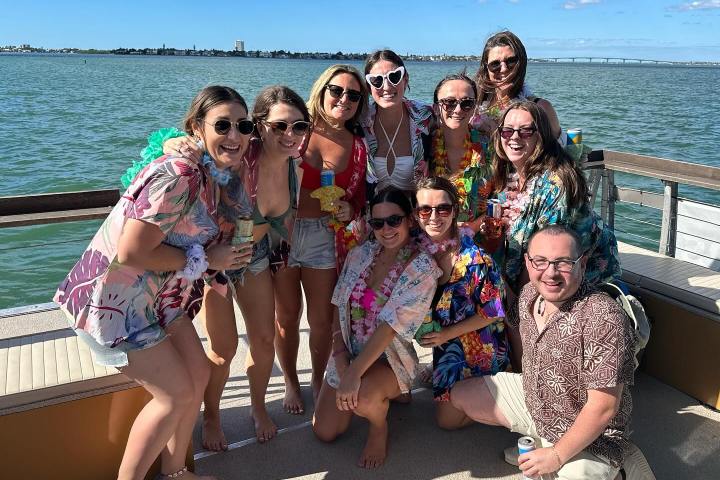a group of people on a beach posing for the camera