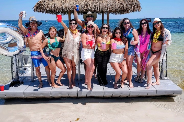a group of people on a beach posing for the camera