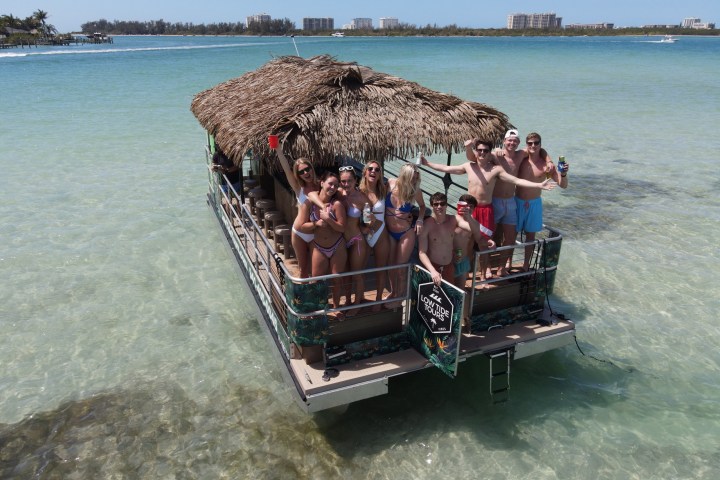 a group of people standing next to a body of water