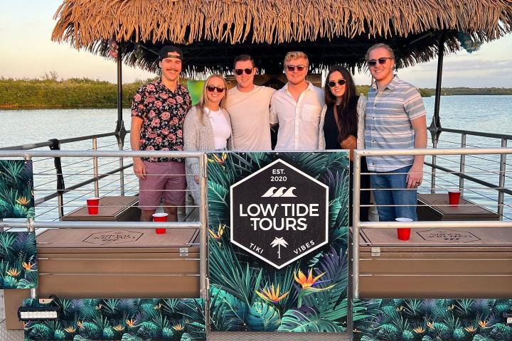 a group of people sitting at a beach
