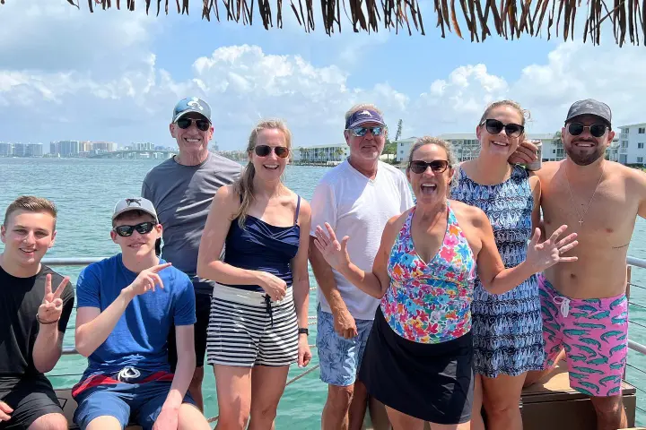 a group of people standing in front of a crowd posing for the camera