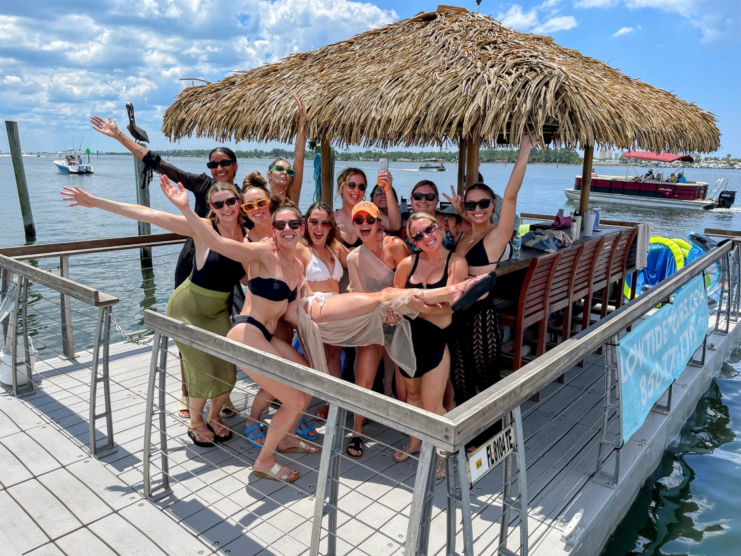 a group of people sitting at a dock